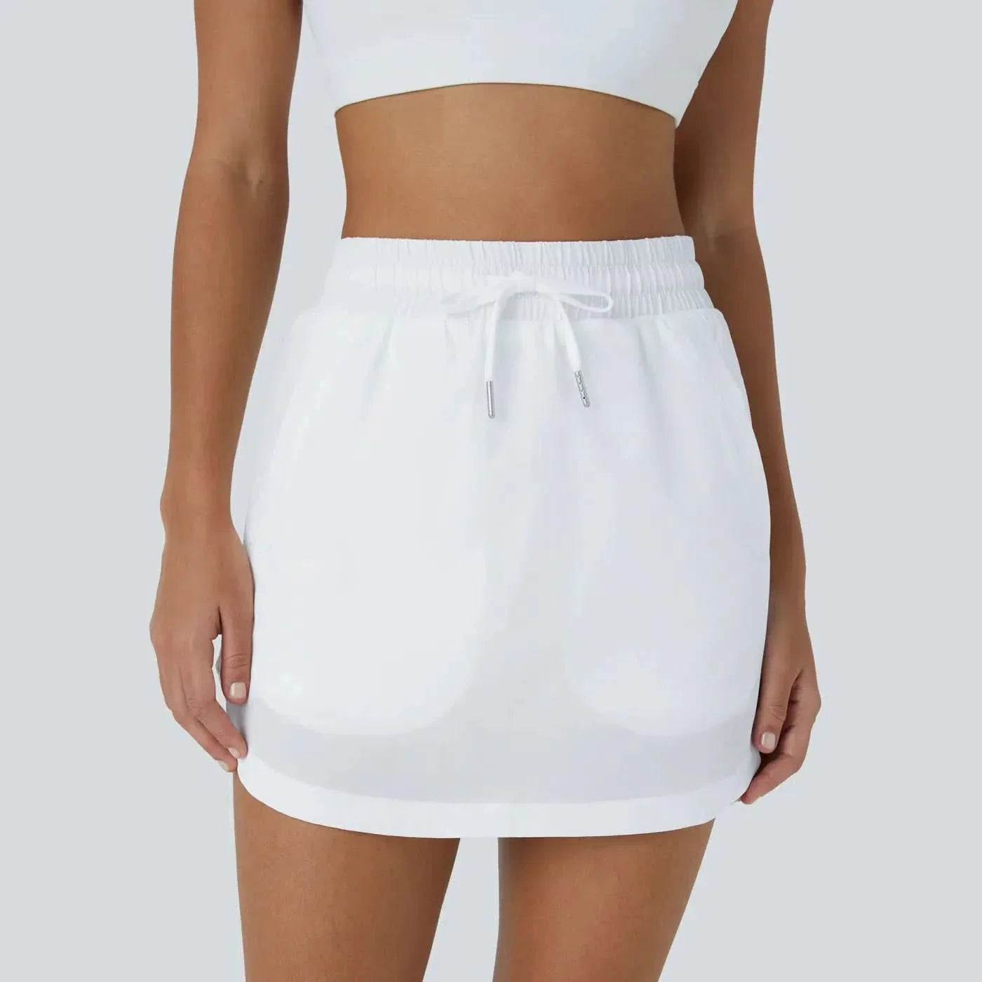 GOLFGLIDE GONNA - Gonna da golf leggera 2-in-1 con shorts integrati e cordino